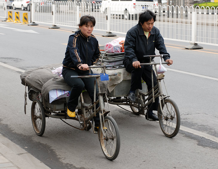 
              Пекин - столица велосипедов. Нигде ранее мне не доводилось наблюдать такого разнообразия педальных транспортных средств. Грузовые и
              пассажирские, простые и электрические, открытые и с будками, велосипеды-мусорки и велосипеды-кухни. Конкурировать с ними на столичных
              улицах способны лишь еще более диковинные мотоциклы и мопеды.
            